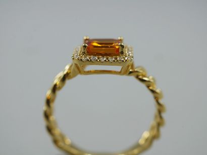 null 18k yellow gold ring set with an emerald-cut yellow sapphire weighing approximately...