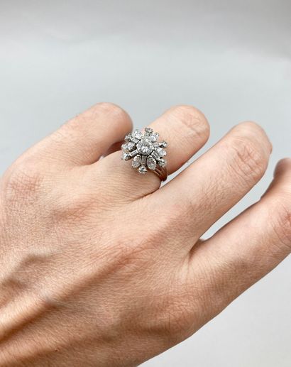null Flower ring in 18k white gold set with brilliant-cut, navette and baguette-cut...