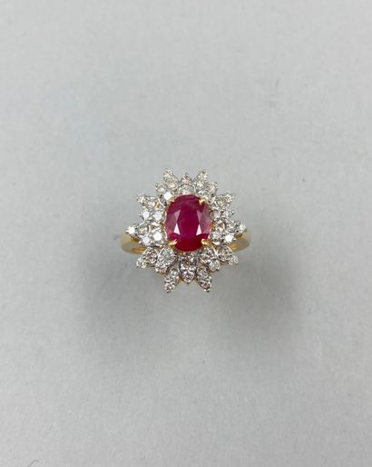 null 18k yellow gold flower ring set with a 1.40ct oval ruby in a double border of...