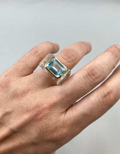 null Ring with cut crystal setting set with an emerald-cut blue topaz of 8cts approximately...