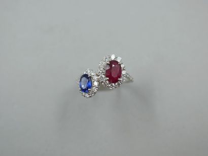 null A platinum Vous Moi ring set with an oval ruby of about 1ct and an oval sapphire...