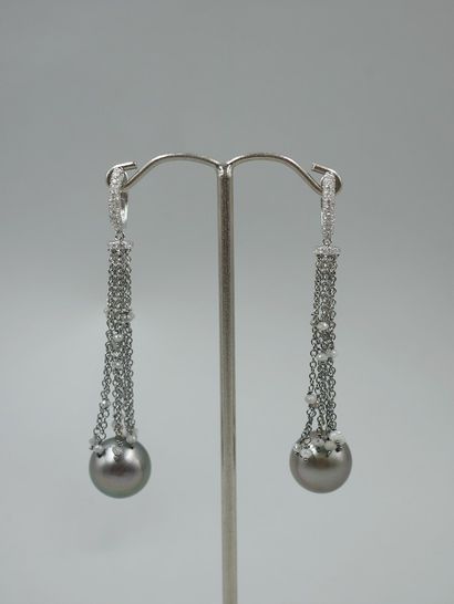 null Pair of 18k white gold pompom earrings with a diamond-paved hoop holding faceted...
