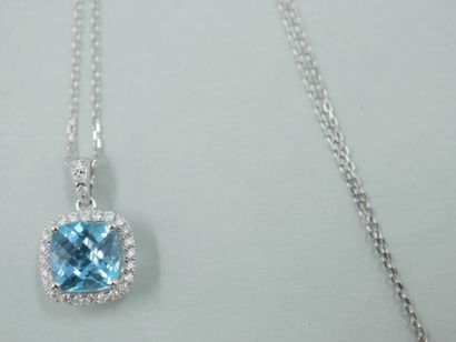 null 18k white gold pendant with a cushion-cut blue topaz of about 2cts encircled...