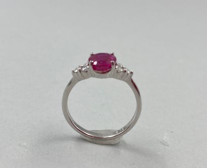 null 18k white gold ring set with an oval ruby of 1.70ct and 3 diamonds forming a...