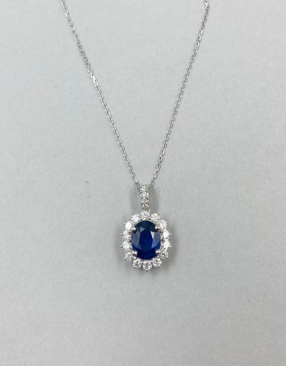 null 18k white gold oval pendant set with a 1.50 ct oval sapphire in a setting of...