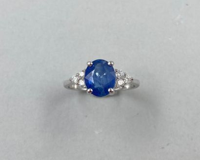 null 18k white gold ring set with a 3cts oval sapphire and 3 diamonds forming a triangle....