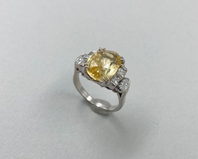 null 18k white gold ring set with a 5.86ct natural yellow Ceylon sapphire with princess...