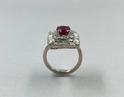 null 18k white gold ring set with a 2ct ruby in a corolla of brilliant-cut and baguette-cut...