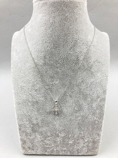 null 18k white gold flower pendant set with baguette and brilliant cut diamonds weighing...