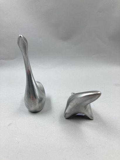 null Two paperweight figures in stainless steel, representing stylized animals.