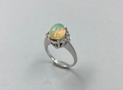 null 18k white gold ring set with an oval opal in an openwork geometrical setting...