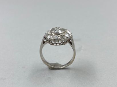null 18k white gold flower ring centered on a 1ct old cut diamond in a diamond setting....