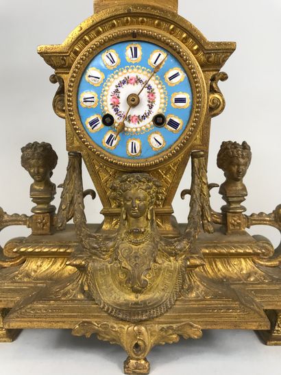 null Clock in gilt bronze, the blue enamelled dial in the taste of Sevres. Surmounted...