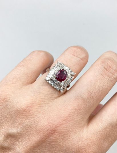 null 18k white gold ring set with a 2ct ruby in a corolla of brilliant-cut and baguette-cut...
