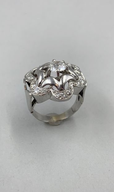 null 18k white gold and platinum flower ring centered on a 0.70ct old cut diamond...