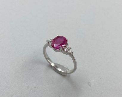 null 18k white gold ring set with an oval ruby of 1.70ct and 3 diamonds forming a...