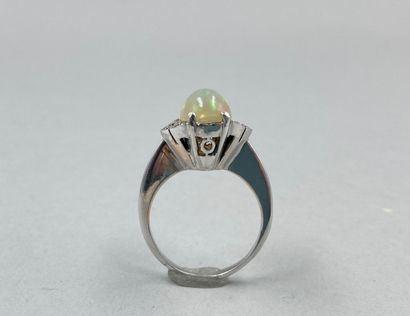 null 18k white gold ring set with an oval opal in an openwork geometrical setting...