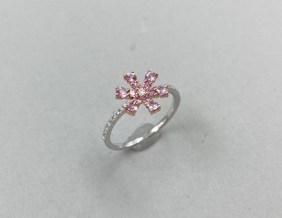 null 18k gold flower ring set with pink sapphires, centered with a diamond, the ring...