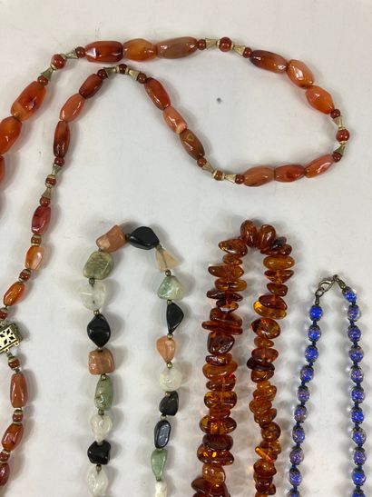 null Lot of costume jewelry including 7 necklaces: two amber necklaces, a necklace...