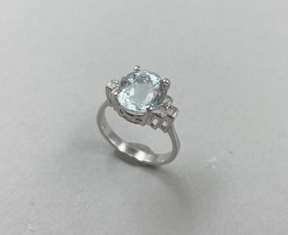 null Art Deco style ring in 18k white gold set with an oval aquamarine and 3 baguette-cut...