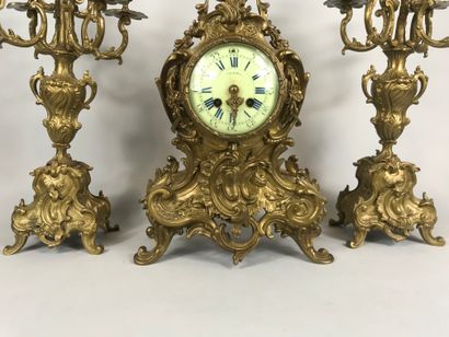 null Gilded bronze mantelpiece including a violin shaped clock decorated with interlacing...