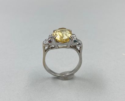 null 18k white gold ring set with a 5.86ct natural yellow Ceylon sapphire with princess...
