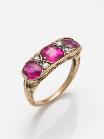 null 18k yellow gold ring set with synthetic rubies and rose-cut diamonds. The setting...