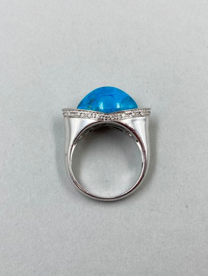 null Bridge ring in 18k white gold set with a cabochon of turquoise and a diamond...
