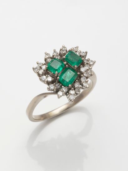null 
Flower ring in 9k white gold topped with three emerald-cut emeralds in a surround...
