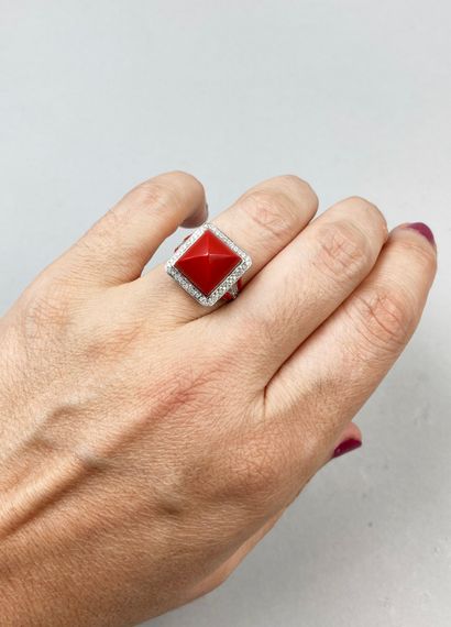 null Ring in 18k white gold, the square bezel centered on a carnelian cut in a sugar...