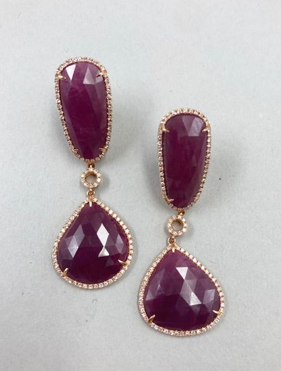 null A pair of 18k rose gold earrings holding faceted rubies surrounded by lines...