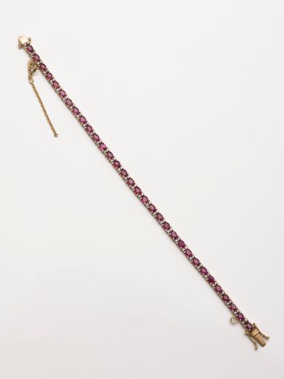 null River bracelet in 18k yellow gold composed of oval cut rubies alternated with...