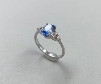 null 18k white gold ring set with a 2.05cts oval sapphire and 3 diamonds forming...