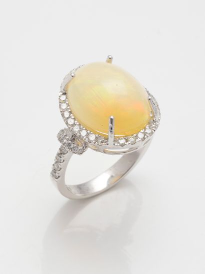 null 18k white gold ring set with a cabochon opal of about 7cts in a diamond setting....
