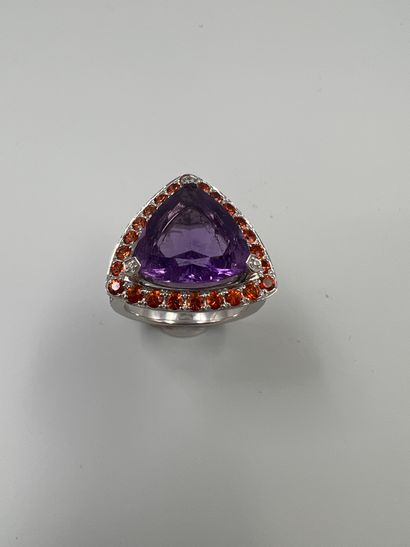 null MAUBOUSSIN 

18k white gold ring set with a trillion cut amethyst underlined...