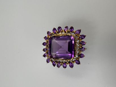null Silver ring set with an important 25cts amethyst in an openwork setting of round...