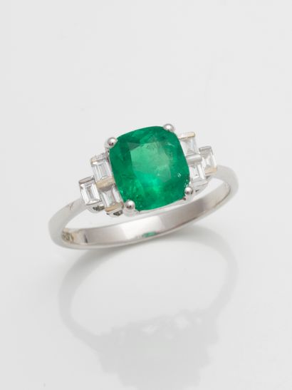 null 18k white gold ring set with a cushion-cut Colombian emerald weighing approximately...