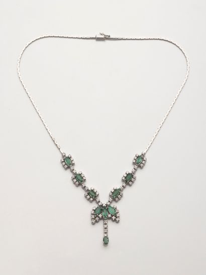 null Necklace in 18k white gold holding petals of emeralds navette cut circled with...