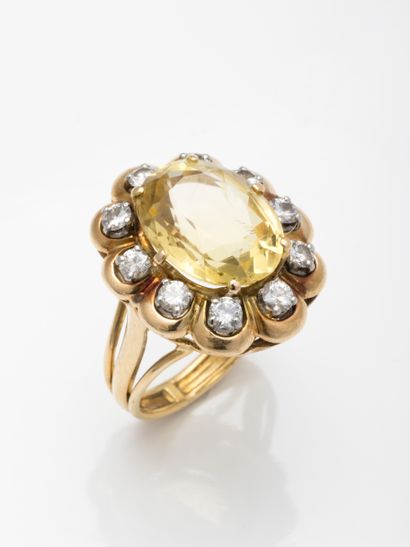 null 18k yellow gold cocktail ring with a large oval citrine in a setting of ten...