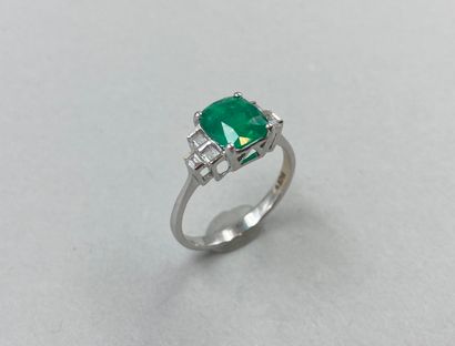 null 18k white gold ring set with a cushion-cut Colombian emerald weighing approximately...