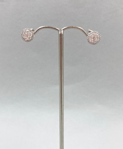 null Pair of earrings in 18k white gold each adorned with a round openwork motif...