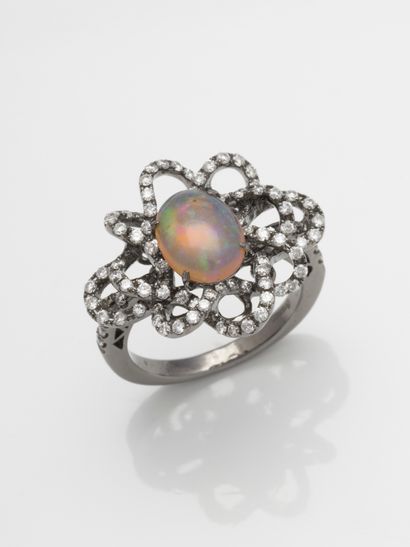 null Ring tourbillon in 18k white gold, in the center a cabochon of opal of 3ct approximately...
