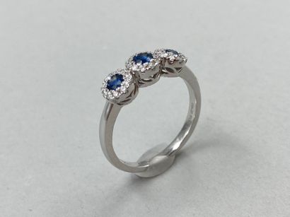 null Trilogy ring in 18k white gold with three motifs each centered on a sapphire...