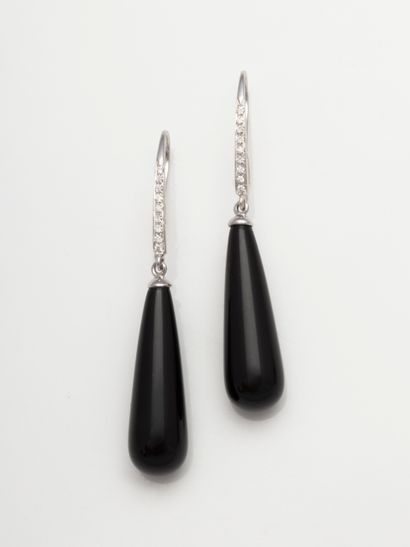 null A pair of 18k white gold earrings, each holding a drop-cut onyx pearl topped...