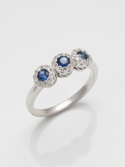null Trilogy ring in 18k white gold with three motifs each centered on a sapphire...