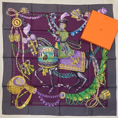 null HERMÈS Paris.

Printed silk square decorated with a rider on horseback playing...