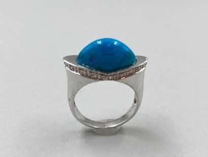 null Bridge ring in 18k white gold set with a cabochon of turquoise and a diamond...