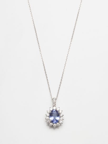null 18k white gold oval pendant set with an oval tanzanite weighing 1.30 ct in a...
