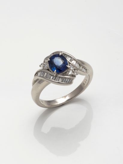 null A platinum ring set with an oval sapphire of about 1.2cts in a circle of brilliant-cut...