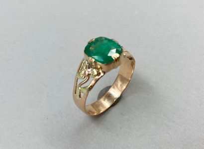 null 18k yellow gold ring set with a cushion-cut emerald weighing approximately 2...